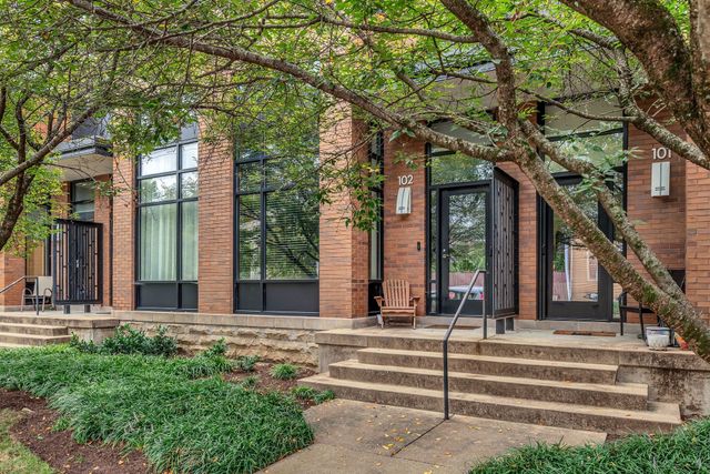 a view of a building with a tree