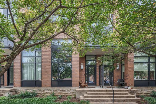 front view of a house with a tree