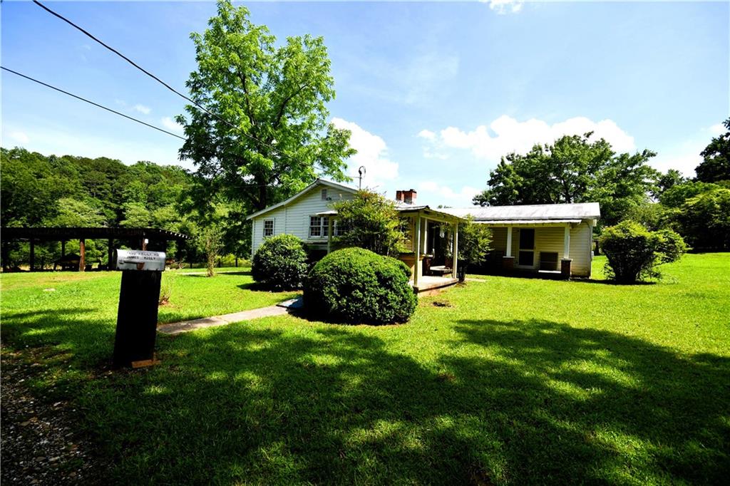 400 Kelley Road Tallapoosa, GA 30176 - Photo 11 of 52 a view of a house with a yard and a garden