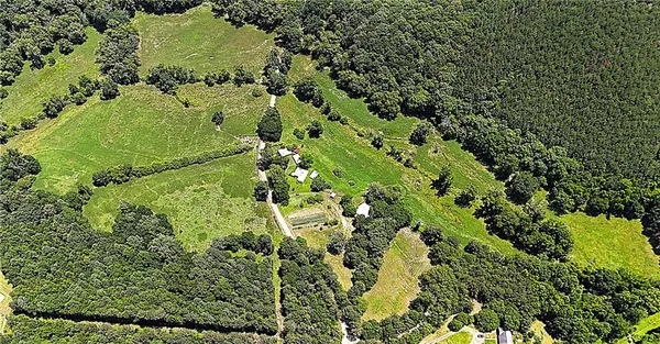 an aerial view of a houses with a yard