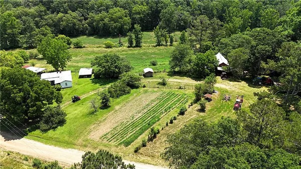 an aerial view of a house with yard swimming pool and outdoor seating