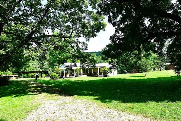 a view of a house with a yard and sitting area
