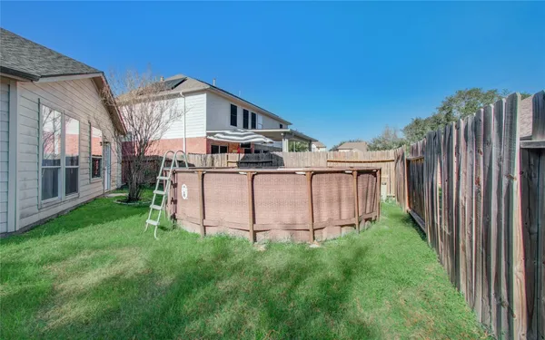 a view of a house with backyard and deck
