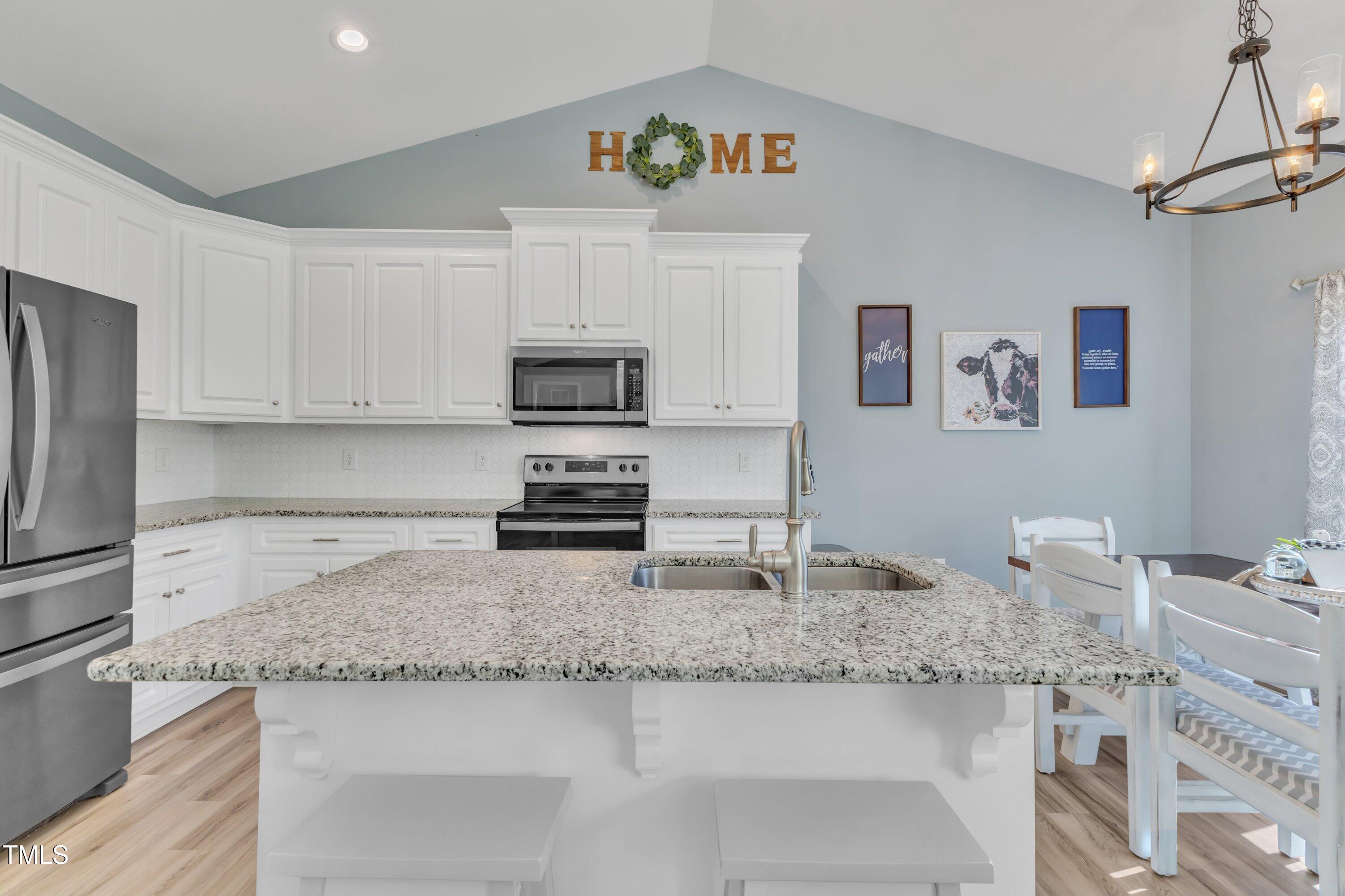 10387 Claude Lewis Road Middlesex, NC 27557 - Photo 11 of 37 a kitchen with stainless steel appliances granite countertop a sink stove and refrigerator