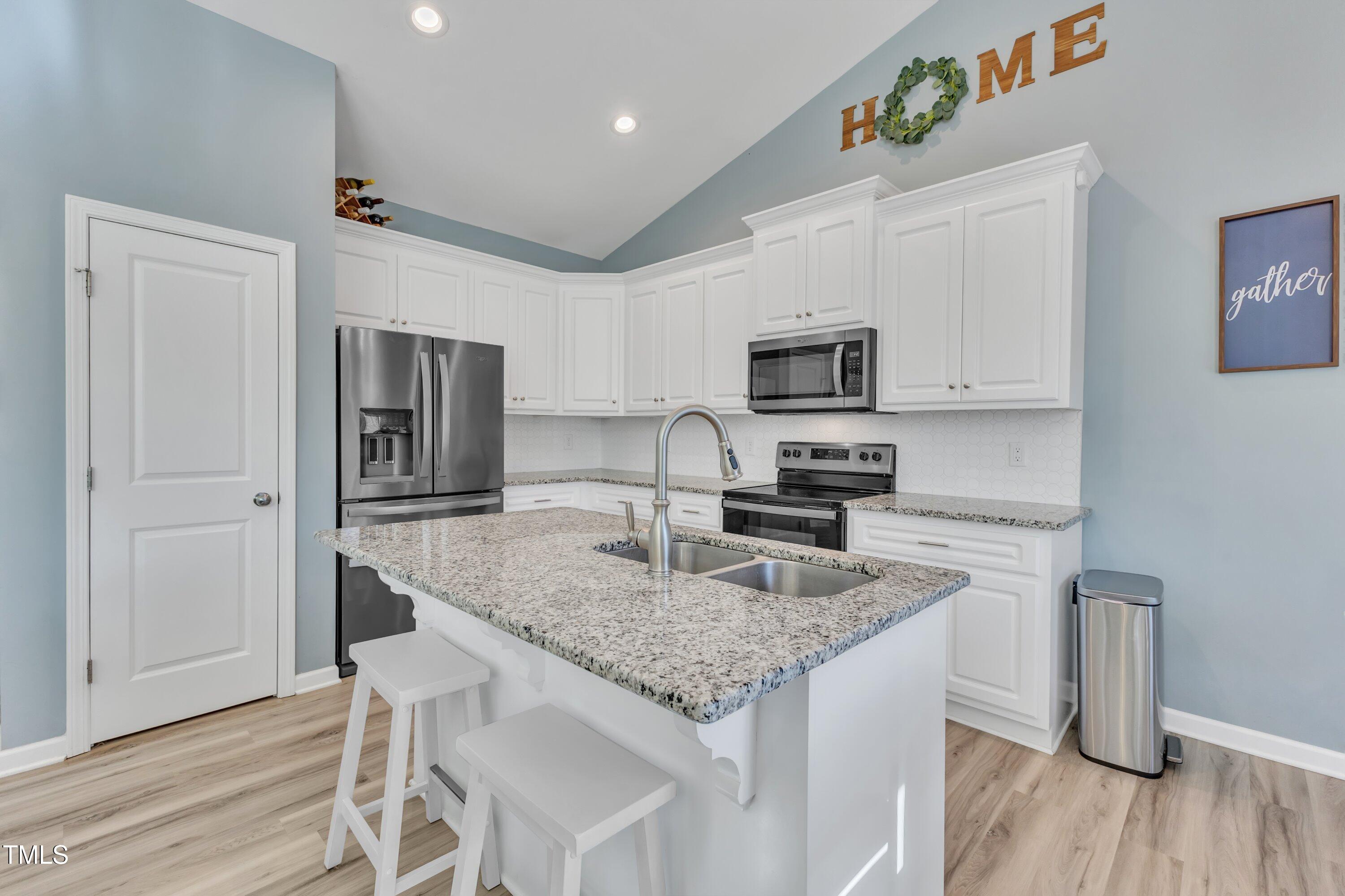 10387 Claude Lewis Road Middlesex, NC 27557 - Photo 12 of 37 a kitchen with granite countertop a refrigerator stove microwave and sink
