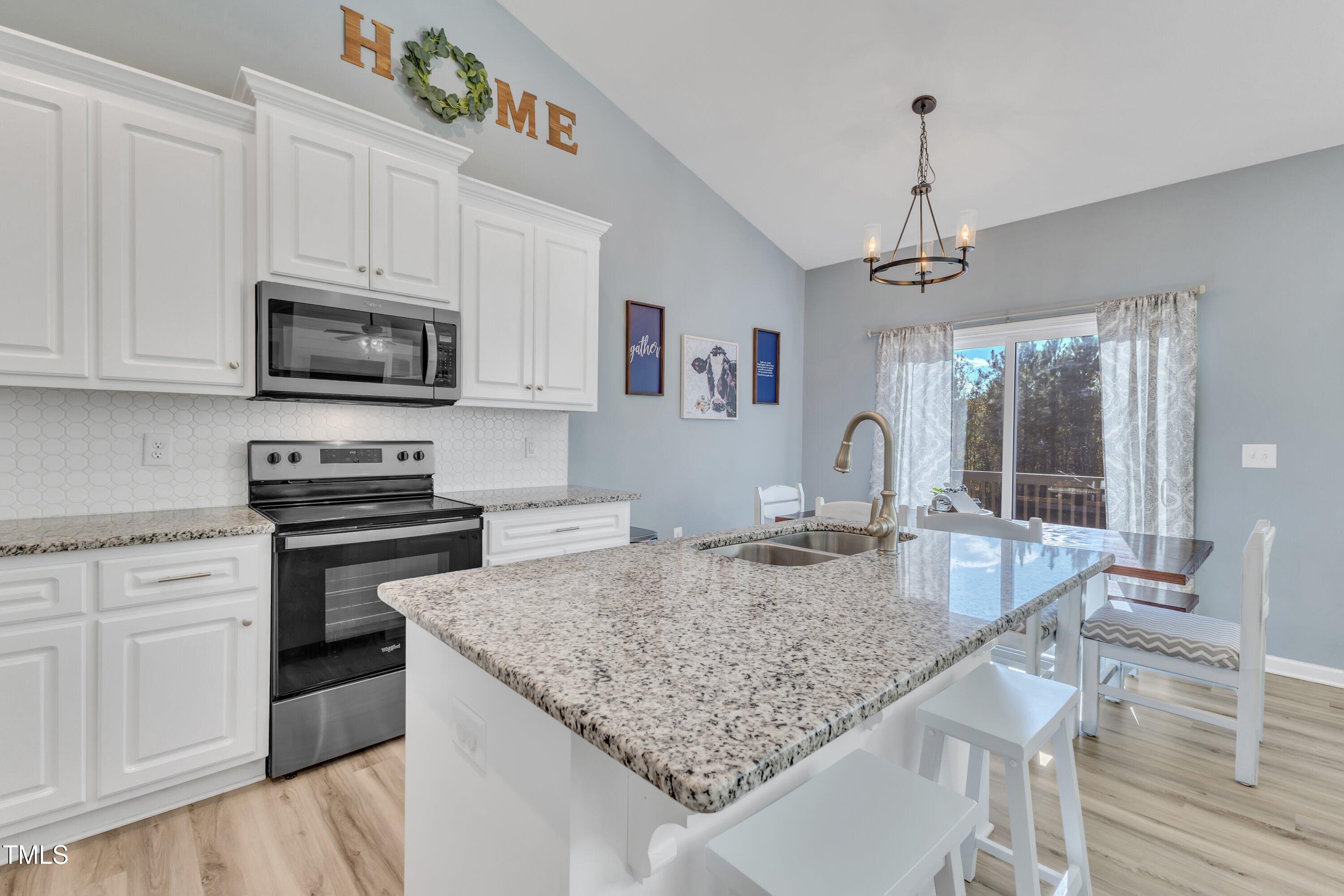10387 Claude Lewis Road Middlesex, NC 27557 - Photo 17 of 37 a kitchen with granite countertop stainless steel appliances a stove sink and microwave