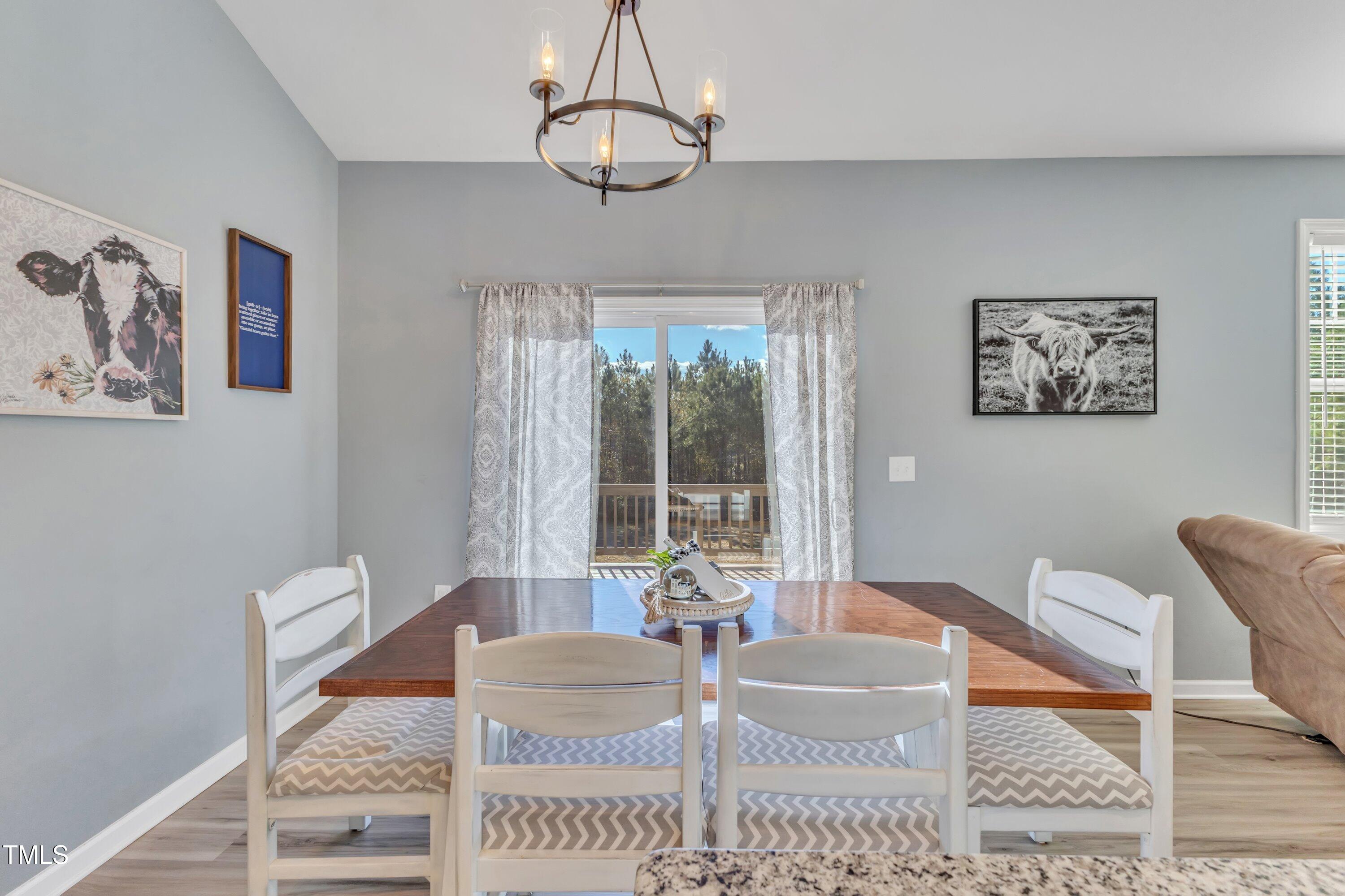 10387 Claude Lewis Road Middlesex, NC 27557 - Photo 18 of 37 a living room with furniture a window and a dining table