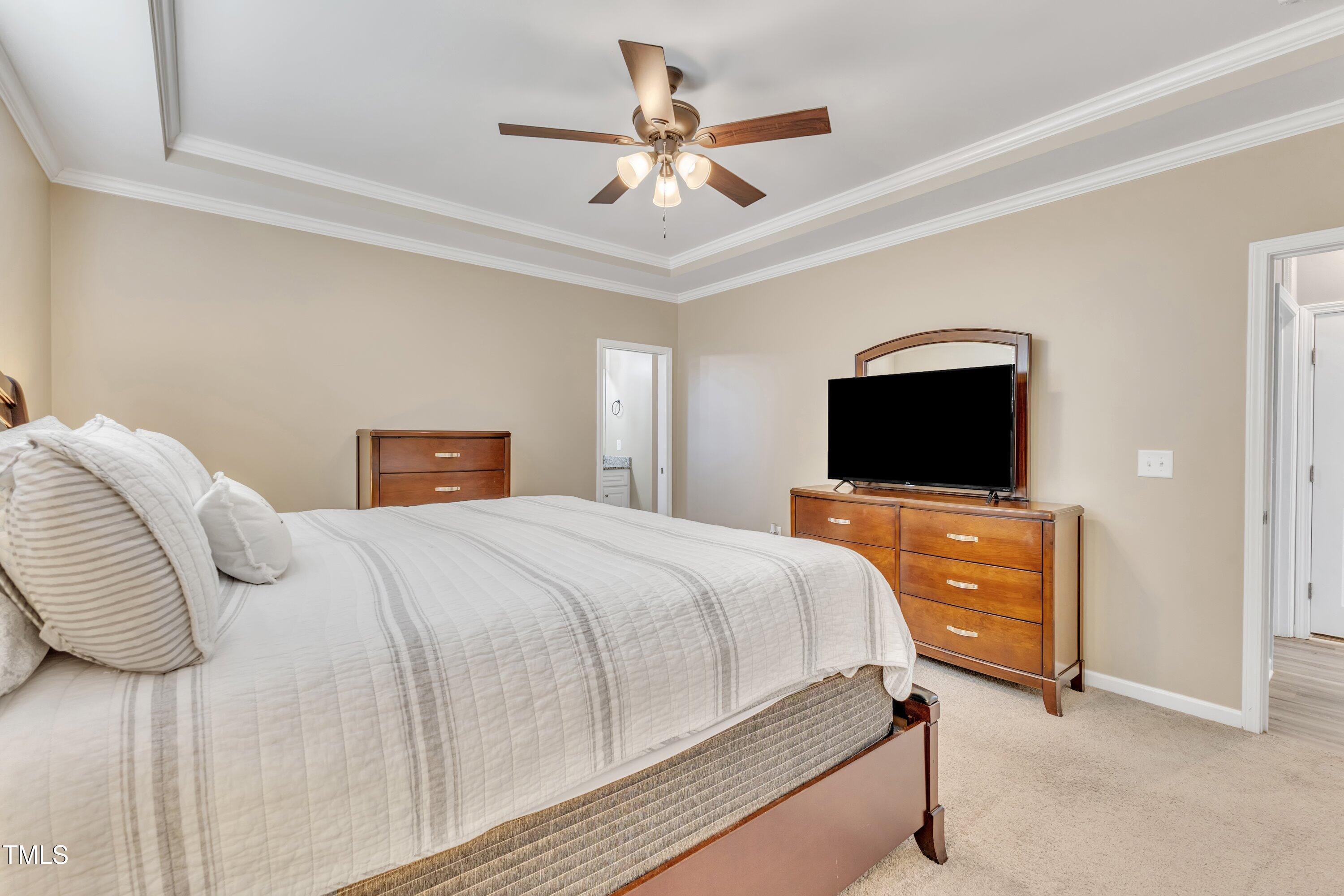 10387 Claude Lewis Road Middlesex, NC 27557 - Photo 20 of 37 a bedroom with a bed and a flat screen tv