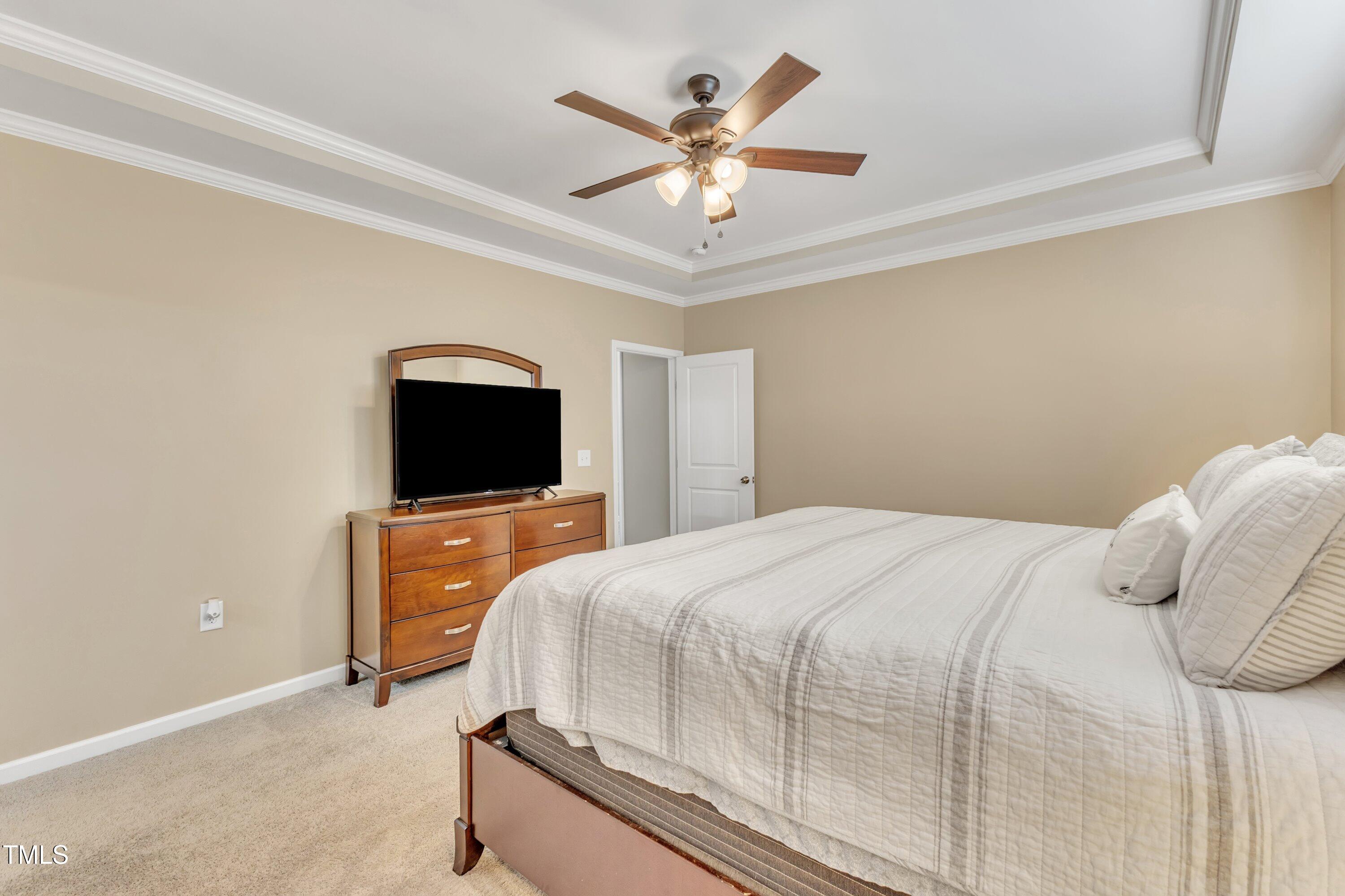 10387 Claude Lewis Road Middlesex, NC 27557 - Photo 21 of 37 a bedroom with a bed and a flat screen tv
