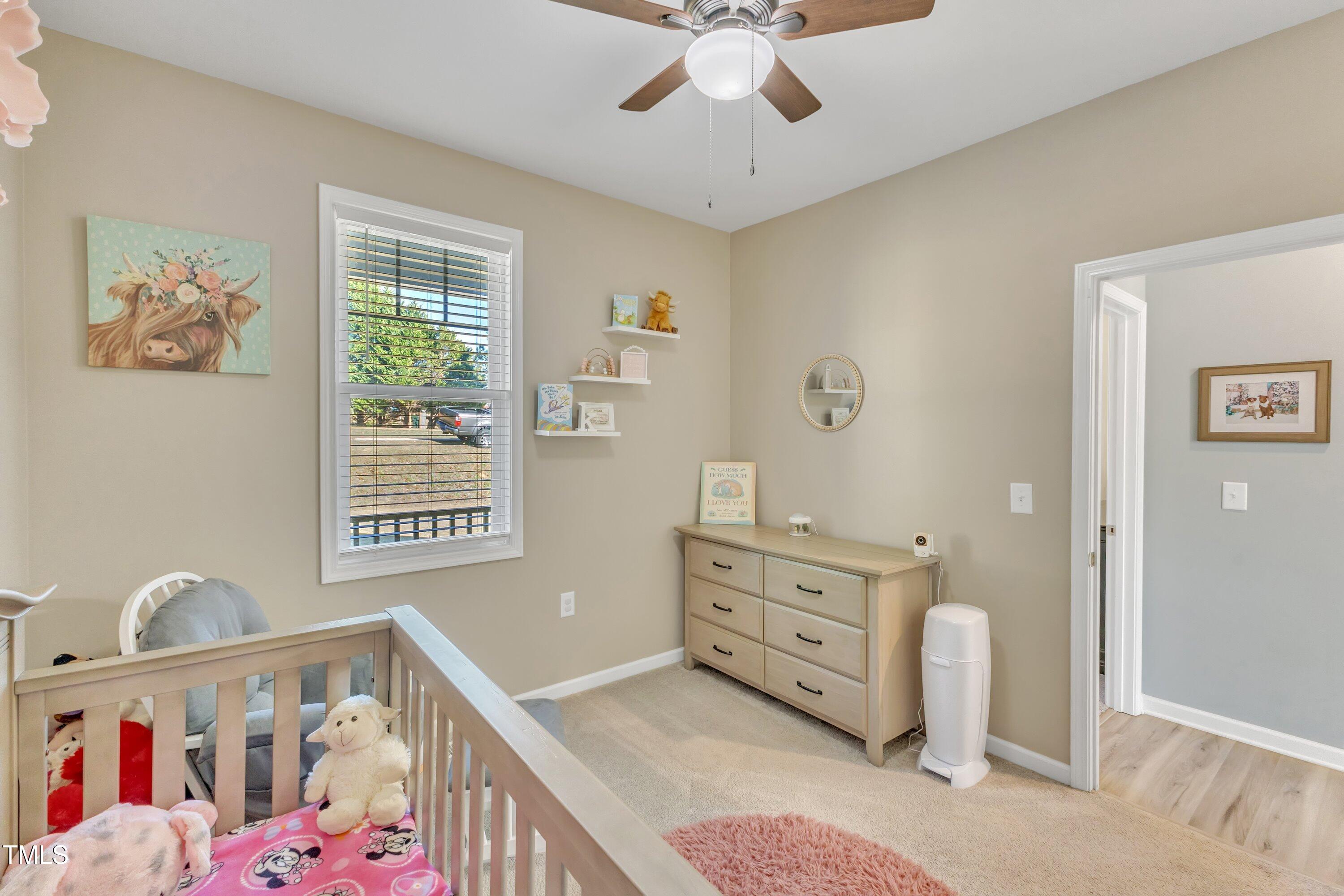 10387 Claude Lewis Road Middlesex, NC 27557 - Photo 30 of 37 a view of a bedroom with baby crib and furniture