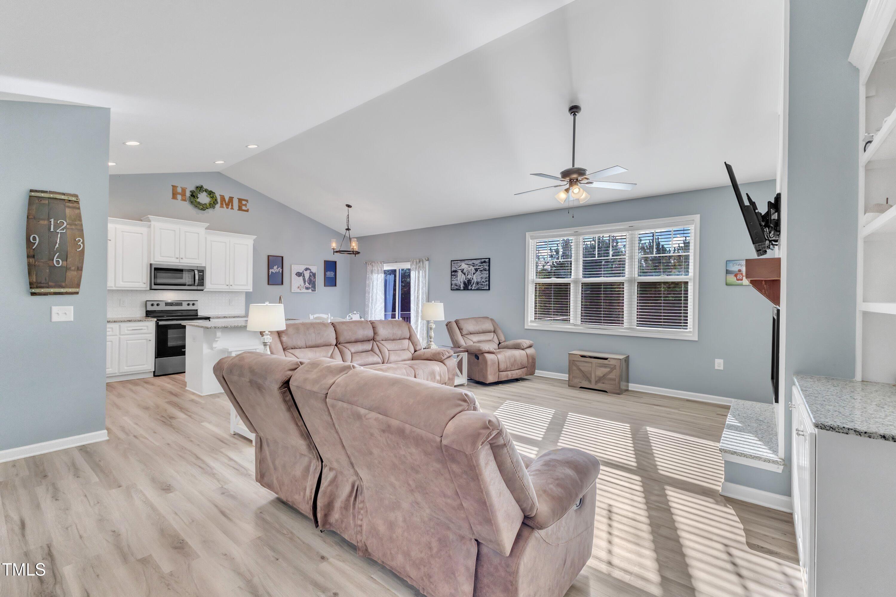 10387 Claude Lewis Road Middlesex, NC 27557 - Photo 6 of 37 a living room with furniture large window and wooden floor
