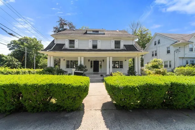 a front view of a house with garden