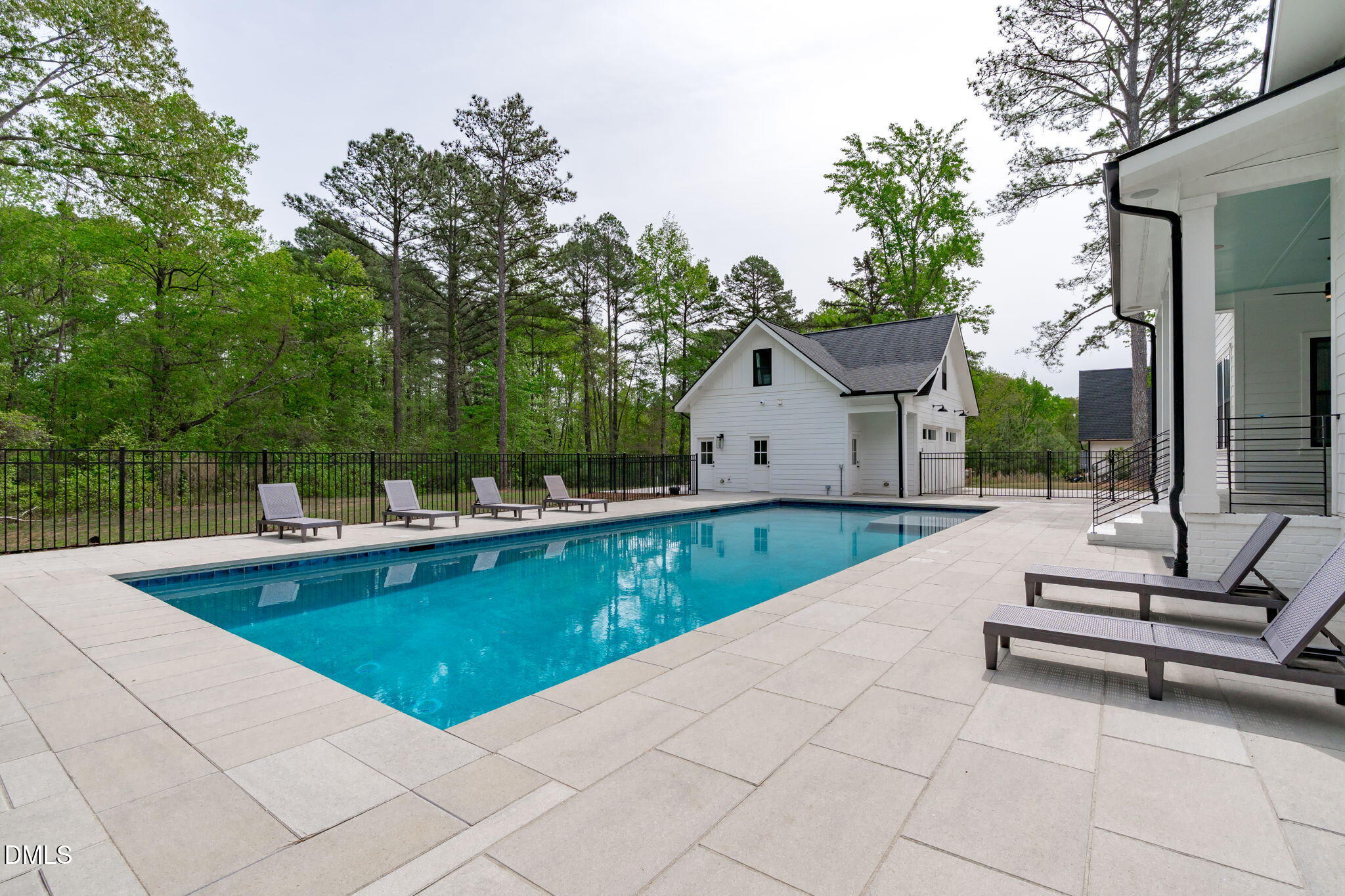 5005 Ten-Ten Road Apex, NC 27539 - Photo 43 of 60 Fenced around pool area, views to detached garage with bonus room, covered back porch.