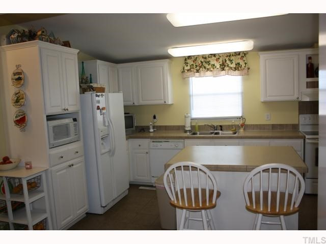 3640 Progressive Church Road Princeton, NC 27569 - Photo 6 of 12 GORGEOUS KITCHEN WITH LOTS OF CABINET SPACE. REFRIGERATOR CONVEYS AND SMOOTH TOP STOVE