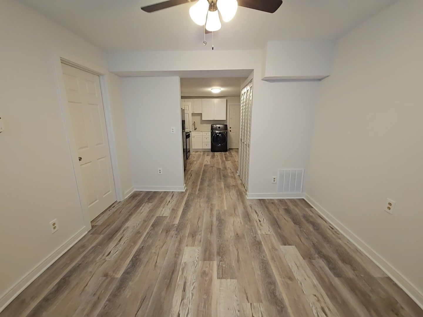 2216 West 21st Place, Unit 1F Chicago, IL 60608 - Photo 4 of 15 a view of a room with wooden floor and a ceiling fan