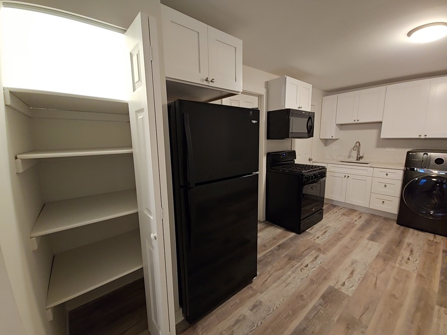 2216 West 21st Place, Unit 1F Chicago, IL 60608 - Photo 5 of 15 a kitchen with a refrigerator stove and sink