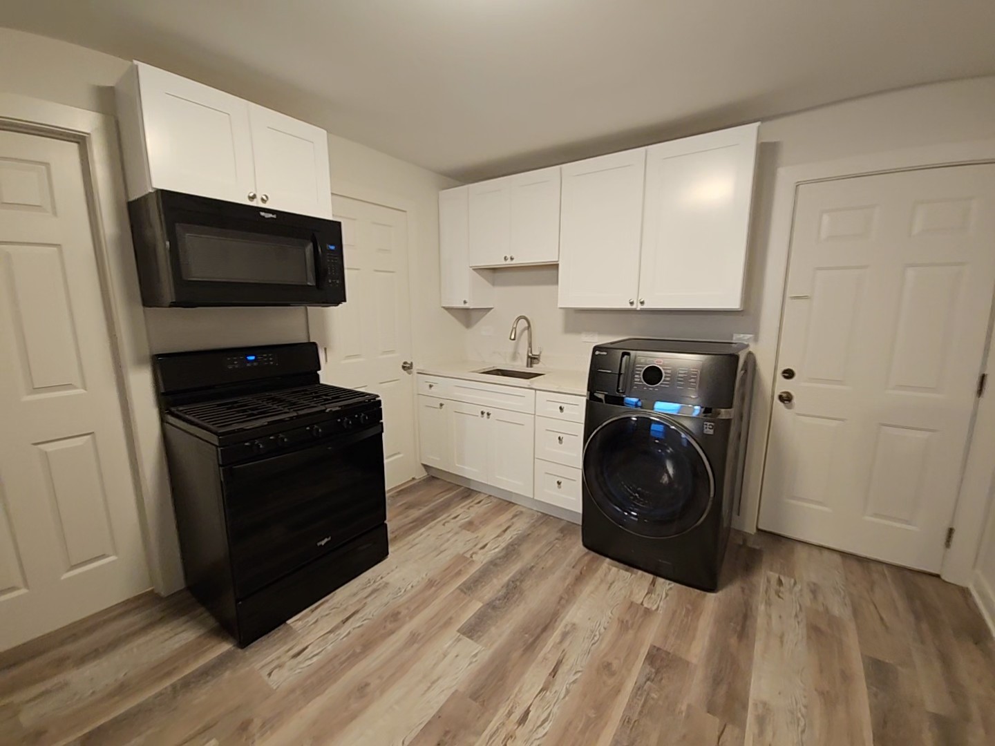 2216 West 21st Place, Unit 1F Chicago, IL 60608 - Photo 6 of 15 a kitchen with a refrigerator stove and microwave