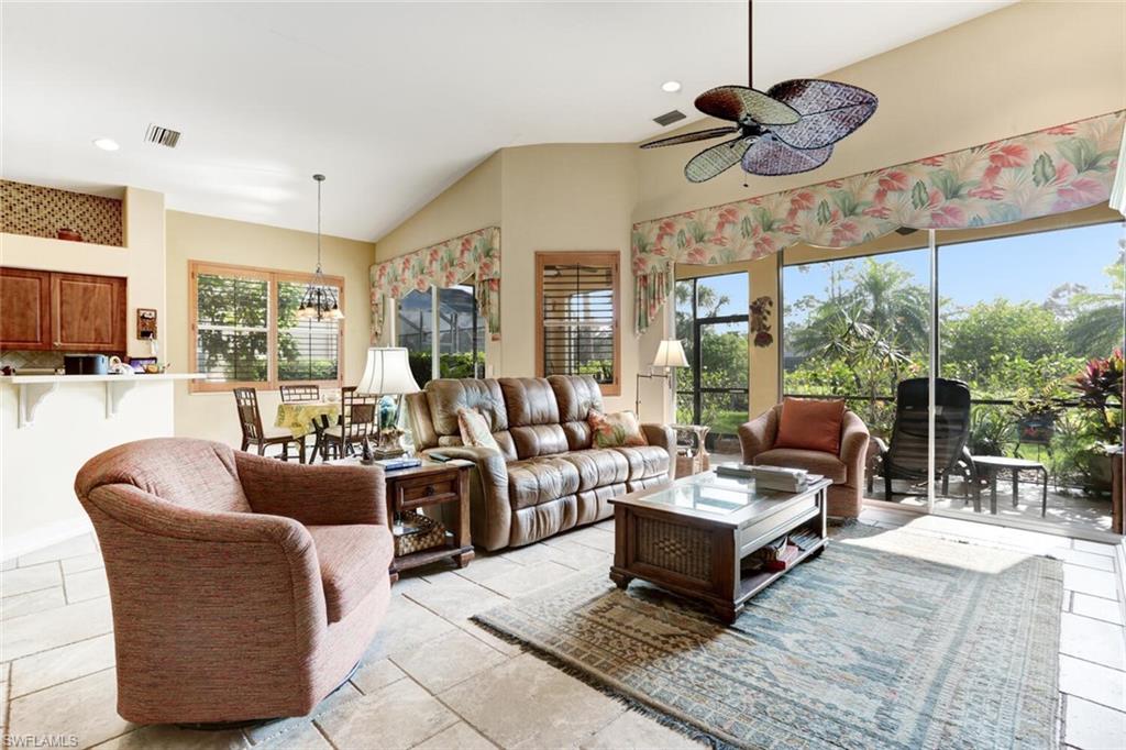 20871 Torrey Pines Way Estero, FL 33928 - Photo 12 of 43 a living room with furniture a flat screen tv and a large window