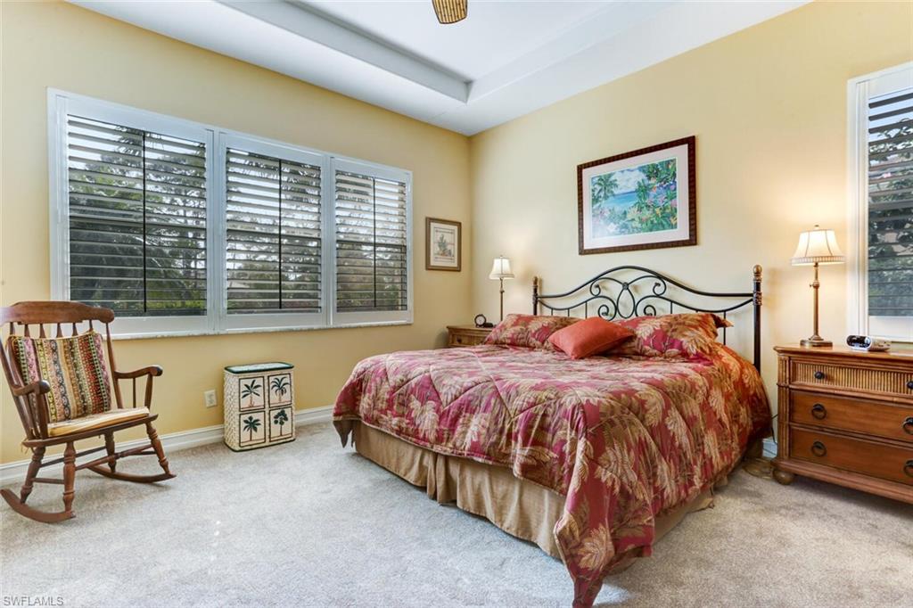 20871 Torrey Pines Way Estero, FL 33928 - Photo 19 of 43 a bedroom with a bed and a couch next to a window