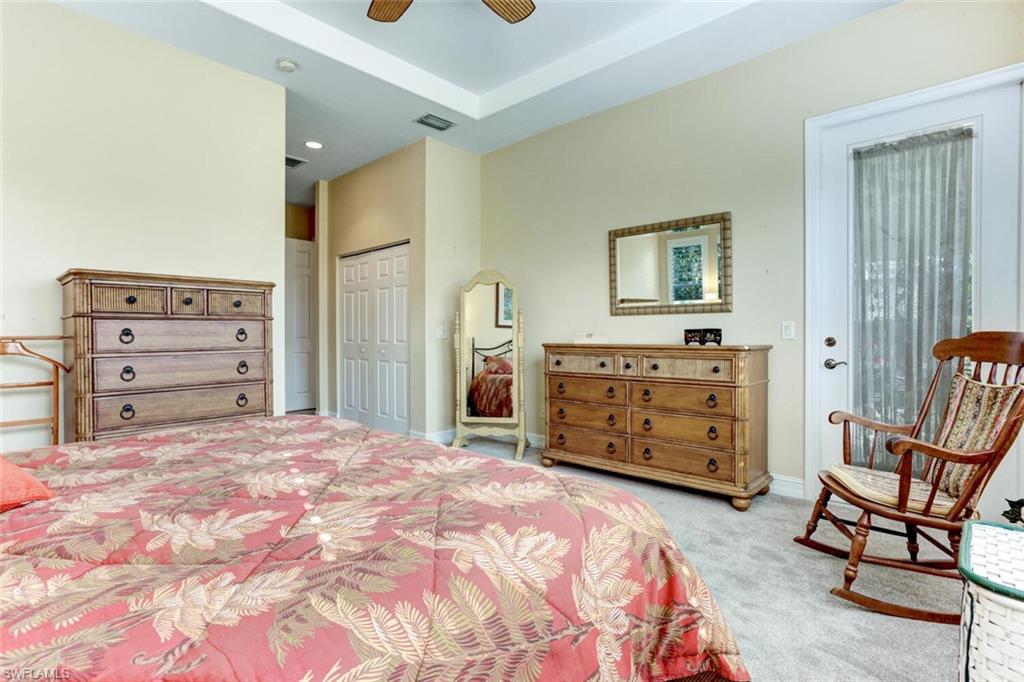 20871 Torrey Pines Way Estero, FL 33928 - Photo 21 of 43 a bedroom with a bed and furniture