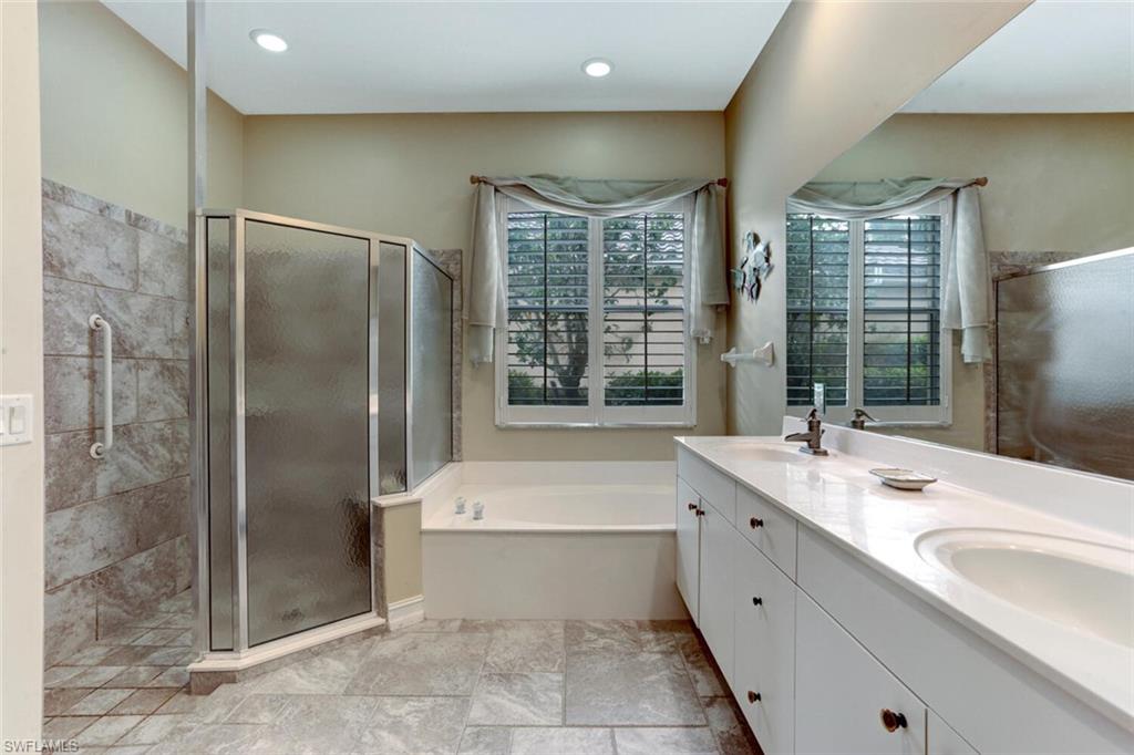20871 Torrey Pines Way Estero, FL 33928 - Photo 22 of 43 a bathroom with a tub sink and double vanity