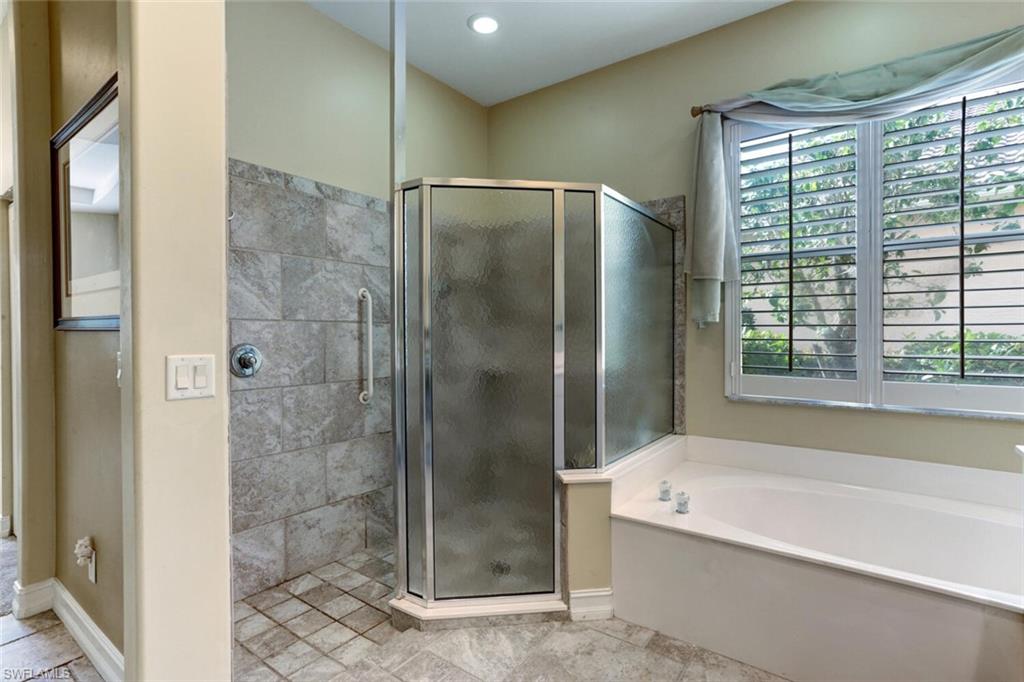 20871 Torrey Pines Way Estero, FL 33928 - Photo 23 of 43 a bathroom with a bathtub and shower