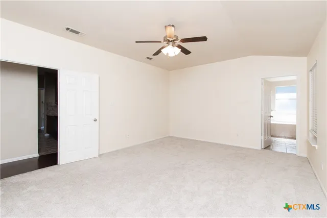 a view of an empty room with a window