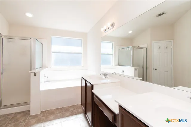 a bathroom with a sink a mirror and a bathtub
