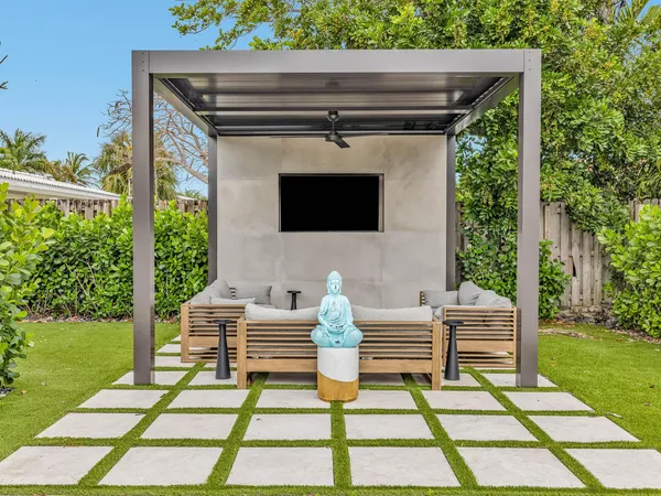a backyard of a house with table and chairs