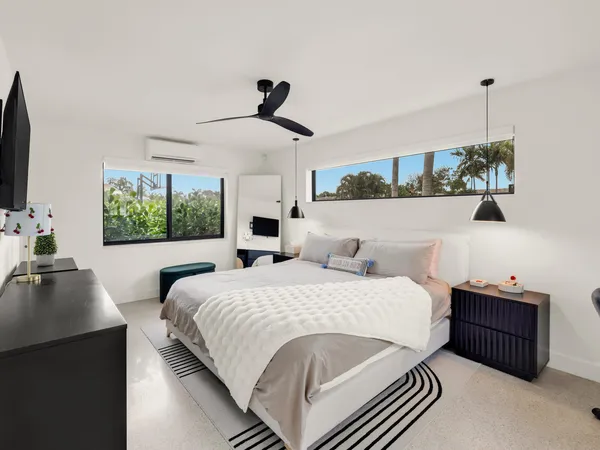 a bedroom with double bed and a window
