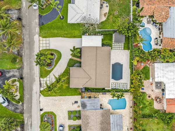 an aerial view of a house with a garden and swimming pool