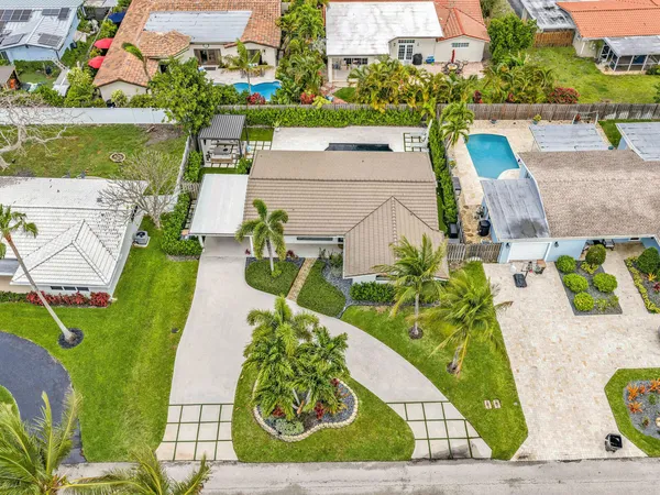 an aerial view of a house with garden space and street view