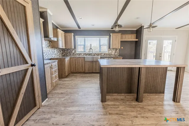 a kitchen with cabinets and window