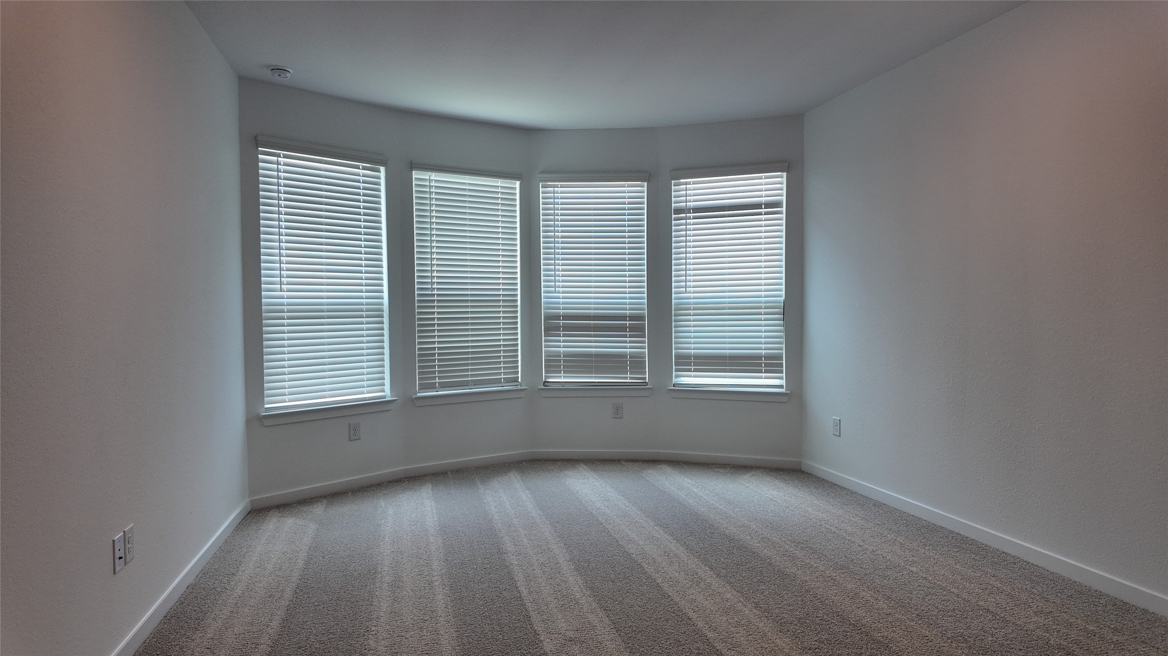 15645 Wandering Maple Way Conroe, TX 77302 - Photo 10 of 14 an empty room with wooden floor and windows