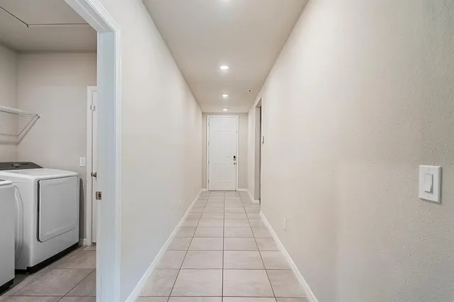 a view of a hallway with washer and dryer