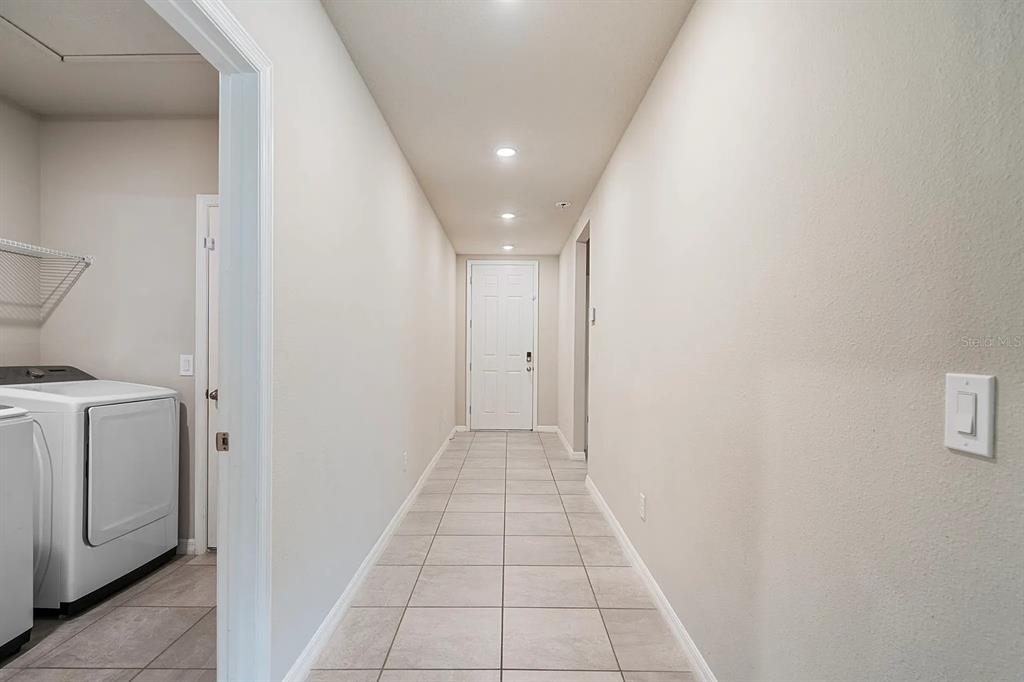 1274 Citrus Landings Boulevard Davenport, FL 33837 - Photo 11 of 20 a view of a hallway with washer and dryer