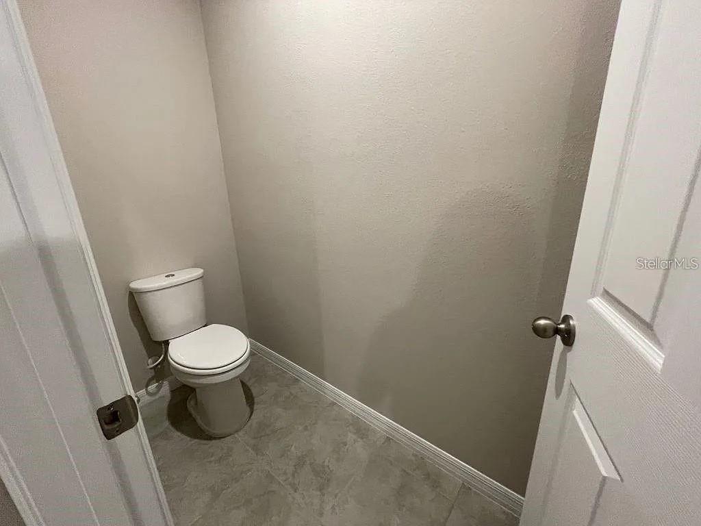 1274 Citrus Landings Boulevard Davenport, FL 33837 - Photo 15 of 20 a white toilet sitting next to a shower