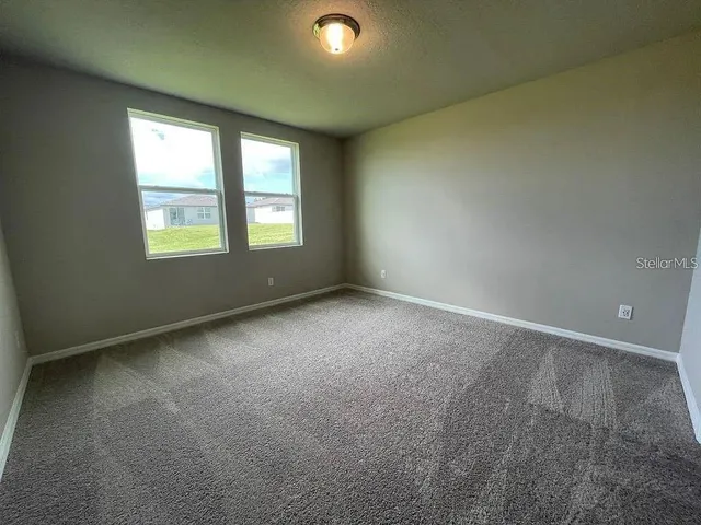an empty room with a empty space and windows