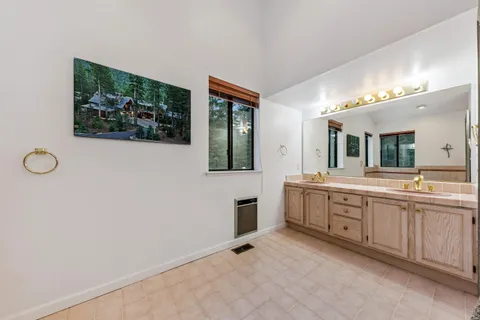 a spacious bathroom with a double vanity sink and a mirror