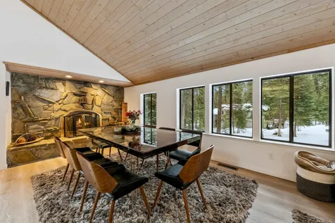 a dining room with furniture and wooden floor