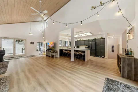 a large room with lots of furniture and a chandelier