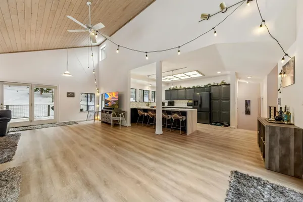 a large room with lots of furniture and a chandelier