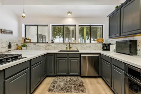 a kitchen with a sink stove and cabinets