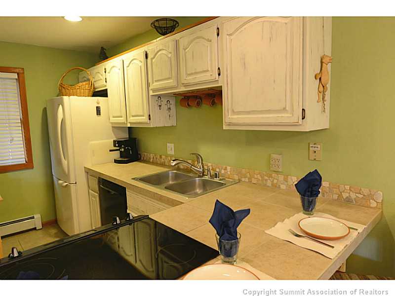 9460 Ryan Gulch Road, Unit 82 Silverthorne, CO 80498 - Photo 8 of 25 Kitchen. Custom tile back splash.