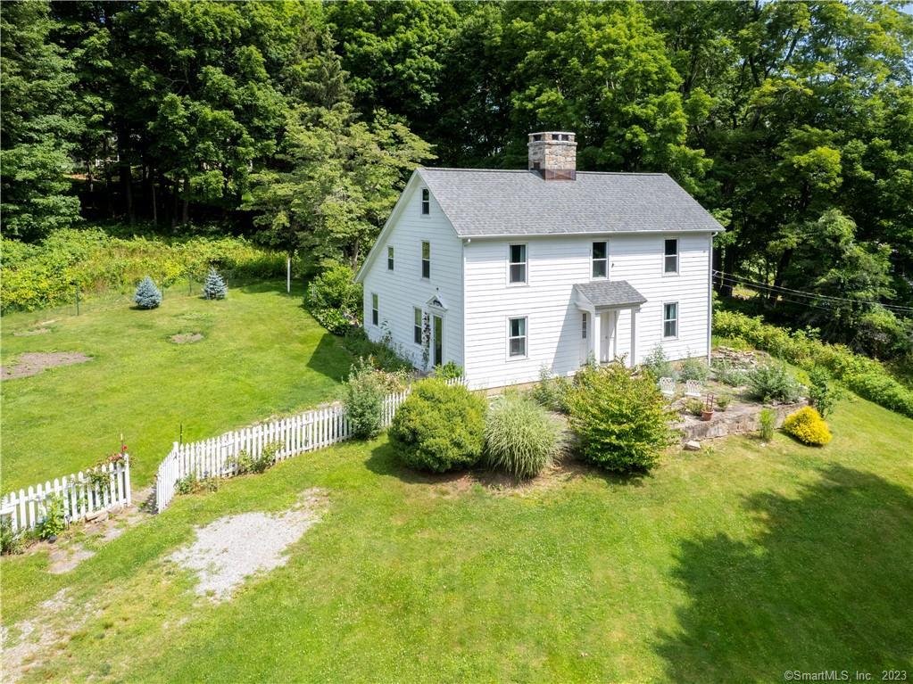 a aerial view of a house with a yard table and chairs