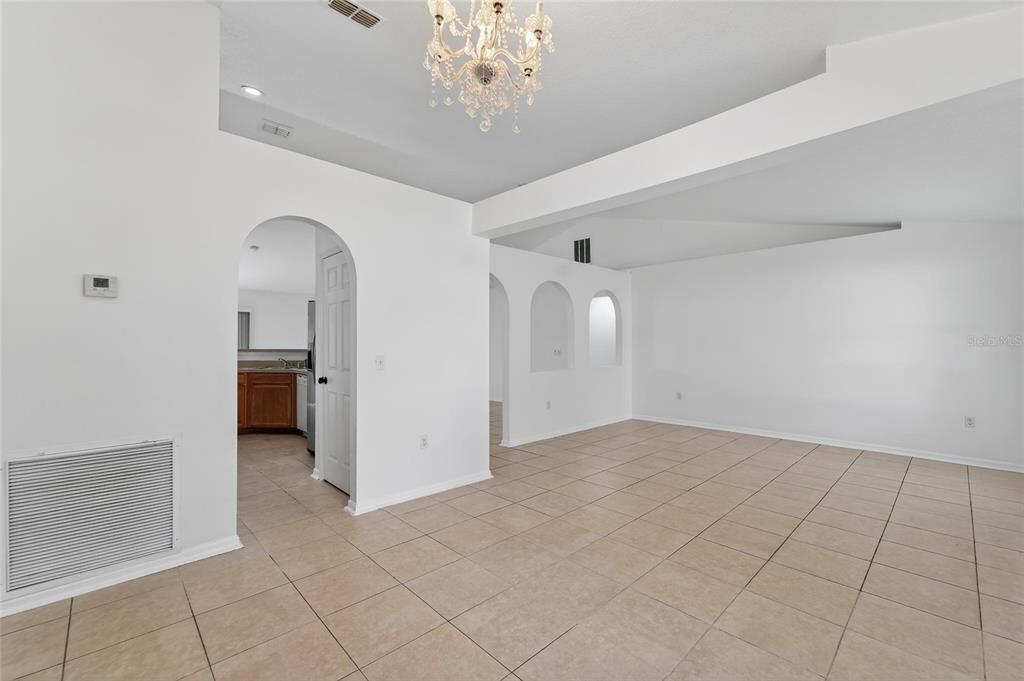 9010 Mc Cormick Street Spring Hill, FL 34608 - Photo 12 of 73 an empty room with chandelier fan