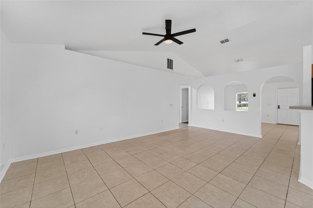 9010 Mc Cormick Street Spring Hill, FL 34608 - Photo 18 of 73 a view of a livingroom with a ceiling fan and window