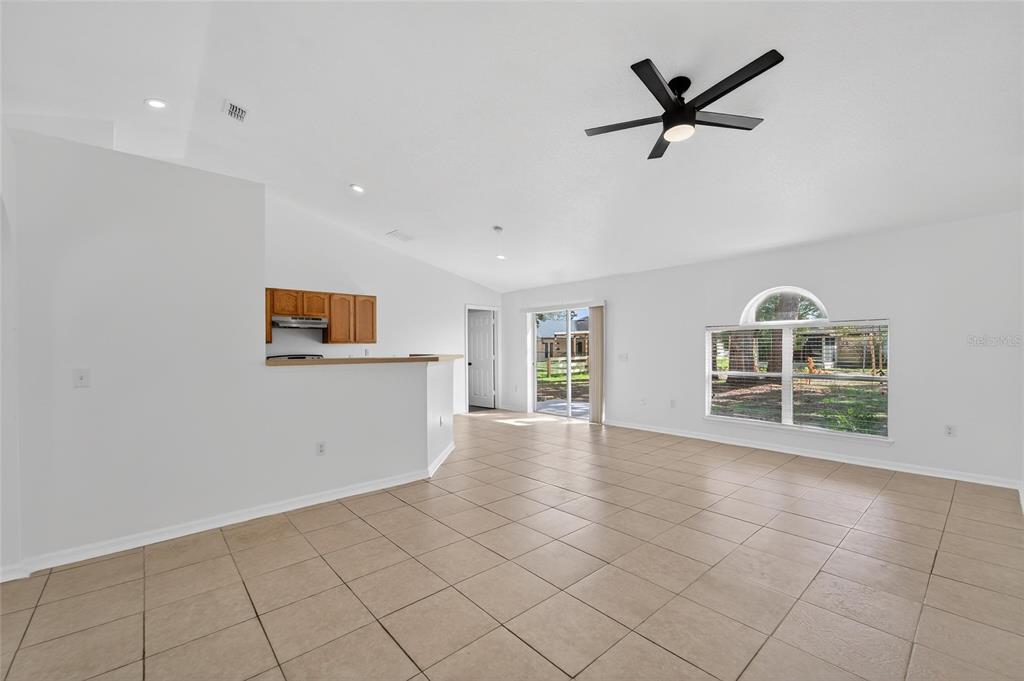 9010 Mc Cormick Street Spring Hill, FL 34608 - Photo 20 of 73 a view of empty room with wooden floor and ceiling fan