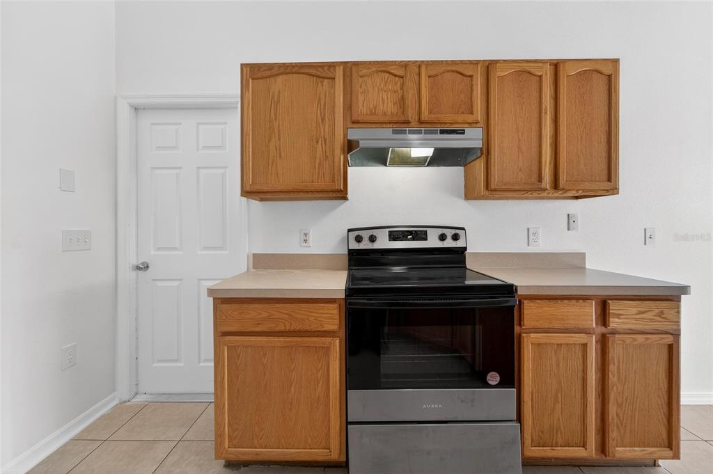 9010 Mc Cormick Street Spring Hill, FL 34608 - Photo 30 of 73 a kitchen with stainless steel appliances granite countertop a stove and a refrigerator