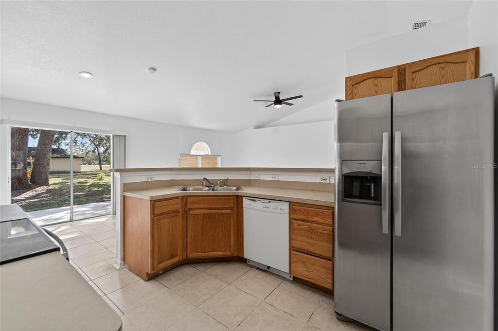 9010 Mc Cormick Street Spring Hill, FL 34608 - Photo 31 of 73 a kitchen with stainless steel appliances granite countertop a refrigerator and a sink